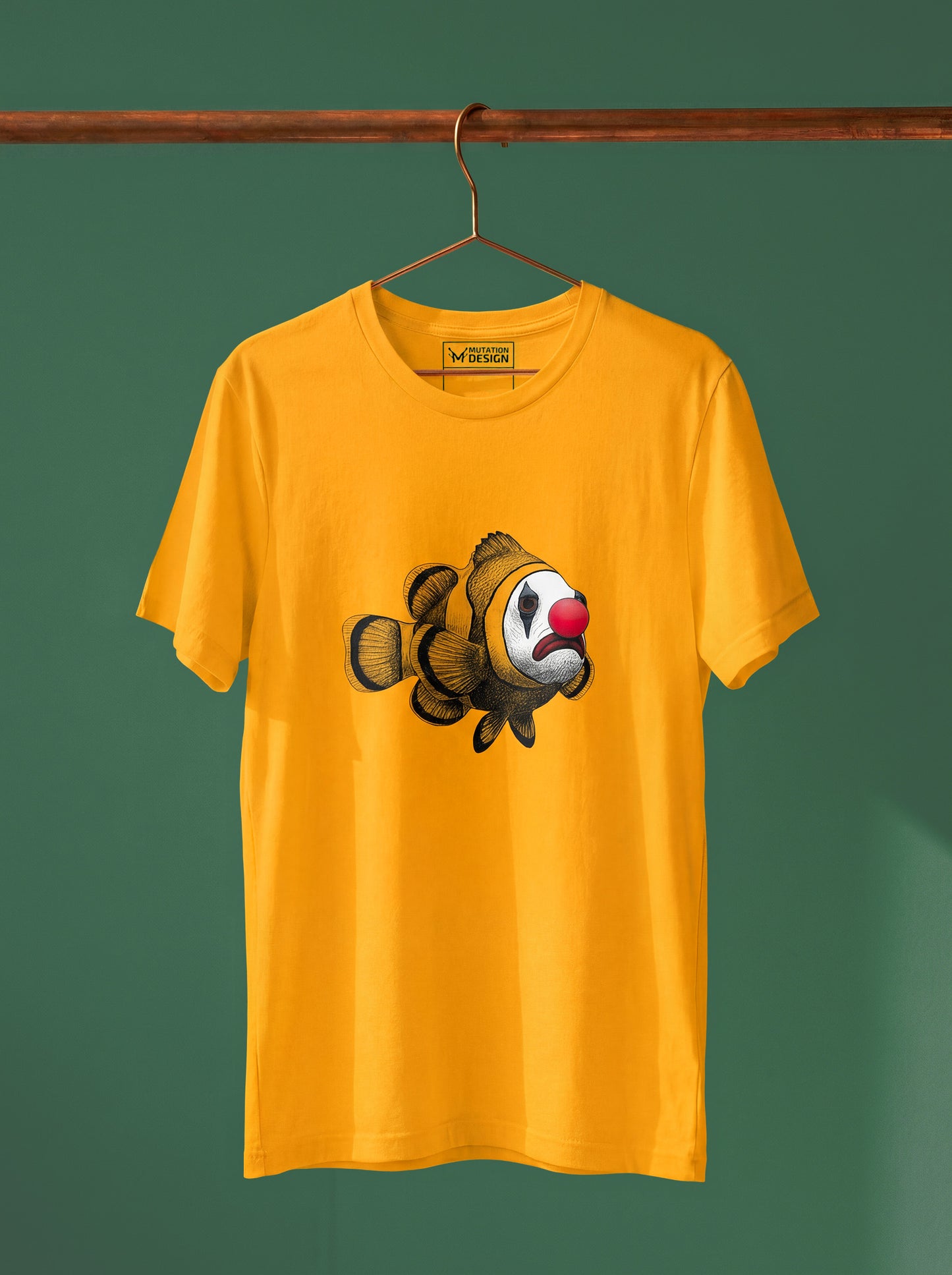 Yellow t-shirt with a clownfish design on a hanger against a green background