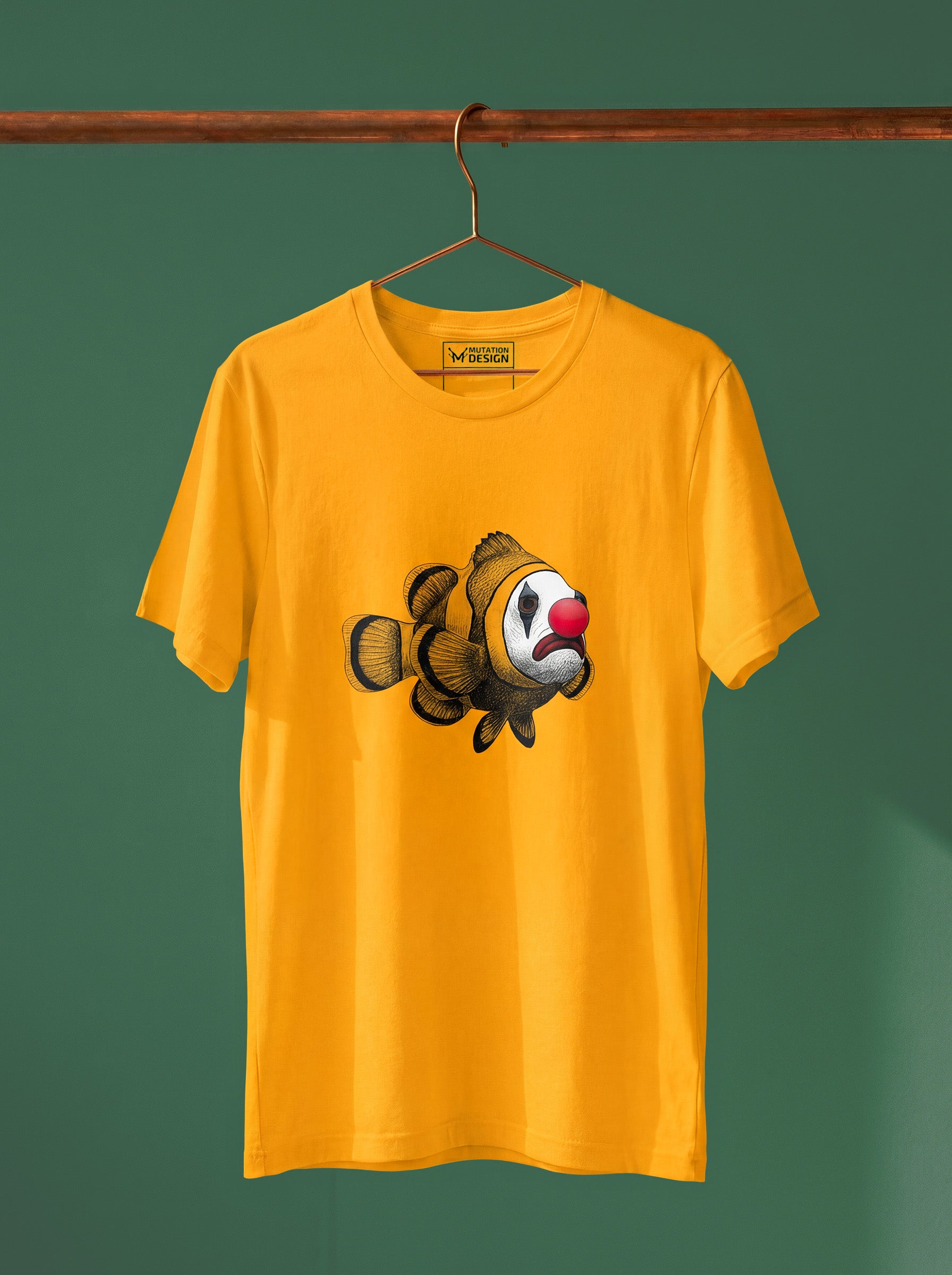 Yellow t-shirt with a clownfish design on a hanger against a green background